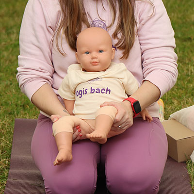 Baby doll with Iogis Bach on its vest
